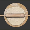 Wooden Rolling Pin on Round Board with Flour and Rolled Dough