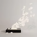 Contemporary Chandelier With Floating White Paper Pieces Scattered From Black Base In Modern Interior