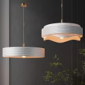 Modern White Striped Pendant Lights Hanging Over Dark Wall With Green Plants