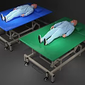 Wheeled Medical Beds with Blue and Green Surfaces and Mannequins on Top
