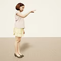 Young Girl Pointing Upward With Index Finger in Pink Short Sleeve Top Yellow Pleated Skirt