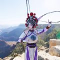 Woman In Traditional Costume With Red Decorated Headdress Holding Circular Ring At Grand Canyon