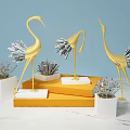 Gold And Silver Crane Decorative Ornament Set On White Bases And Orange Display Stands
