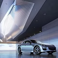 Modern Exhibition Hall Featuring Silver Car With Geometric Ceiling Lighting Gray Walls And Smooth Floor