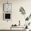 Black and White Abstract Paintings With Geometric Wavy Patterns On Wall And Green Plant Decor