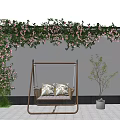 Cozy Hanging Swing Chair with Cushions Under Pink Flowering Vines on White Wall and Sapling