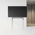 Modern Flat Screen TV on Sleek Stand With Wooden Legs And Minimalist White Interior Space