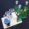 Elegant Green Wine Bottles and Wine Glasses on White Tray with Metal Canister and Box