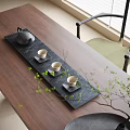 Natural Tea Set with Black Teapot Three Teacups Saucers on Wooden Table and Green Plant