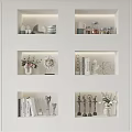 Decorative Ornament Combinations on White Display Shelves with Vases Sculptures Books and Warm Lighting