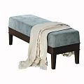 Light Blue and Beige Upholstered Sofa Bench with White Blanket Draped Over Dark Legs