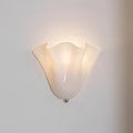 White Flower Shaped Wall Light With Soft Illumination Mounted On White Wall