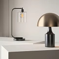 Modern Table Lamps Featuring Black Stand Transparent Shade And Gold Dome Base On White