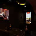 Modern KTV Private Room Interior With Large Screen Wine Bottles And Glasses