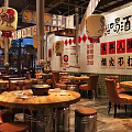 Traditional Hotpot Restaurant with Red Lanterns Chinese Signs Wooden Tables and Leather Seats