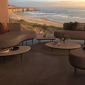 Outdoor Sofa with Coastal Ocean View at Sunset and Modern Coffee Table Decor