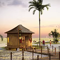 Rural Self Built House With Wooden Thatched Roof And Palm Trees Near Beach At Sunset