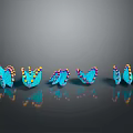 Five blue butterflies with yellow and red spots arranged on black background with reflections