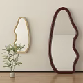 Two Unique Shaped Mirrors With Golden And Dark Red Frames Near Green Plant