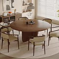 Round Wooden Dining Table Set With Six Beige Cushioned Chairs On Rug And Pendant Light