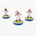 Three Pink Character Figurines Standing on Circular Bases with Colorful Platforms