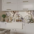 White Kitchen Sink With Brass Faucet Marble Patterned Backsplash And White Cabinets On Kitchen Countertop
