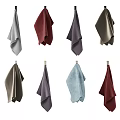 Assorted Colored Towels Hanging On Wooden Rods For Home Bathroom Decor