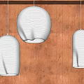 Three Light Blue Wavy Texture Pendant Lights Illuminated On Wooden Wall With Warm Glow