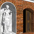 Traditional Red Brick Multi Story Building With Red Tile Roof Arched Windows And Wooden Accents