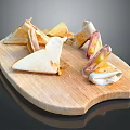 Triangular Stuffed Sandwiches On Wooden Cutting Board With Cheese And Ham Fillings