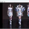 Three Women Walking In Stylish Modern Futuristic Outfits With Unique Shoulder Design And Colorful Details