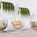 Stylish Hanging Chairs With Cushions And Green Plants On Outdoor Patio