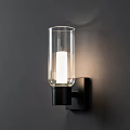 Modern Wall Sconce with Transparent Glass Shade Black Fixture on Dark Wall Illuminated