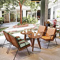 K Cafe Interior Featuring Brick Wall Wooden Panel Green Chairs Brown Bench And Large Plant