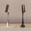 Stylish Faucets with Different Finishes on Light Gray Countertop and Beige Wall