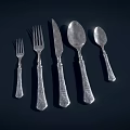 Elegant Silver Cutlery Set Featuring Forks Knives Spoons And Decorative Handles On Dark Background