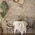 Dining Table Set with White Lace Tablecloth Brown Chairs Palm Plant Stone Wall Decorative Plates