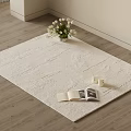 Light Textured Square Rug on Wooden Floor with White Flowers Open Book and Small Candles