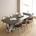 Modern Table And Chairs Set Black Top Mixed Chairs Open Book Fruit Tray Bright Room