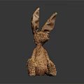 Brown Fluffy Stuffed Rabbit Toy With Long Ears Sitting On Dark Background