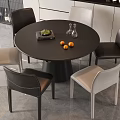 Modern Dining Table Set Round Black Table With Black And Beige Chairs Oranges Glass Vases