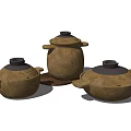 Set of Three Brown Casserole Pots With Black Lids And Handles For Home Kitchen
