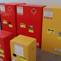 Various Colored Industrial Storage Cabinets with Warning Signs and Safety Labels