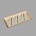 Three Delicious Macarons With White Frosting And Chocolate Drizzle On Ivory Rectangular Plate