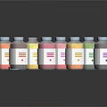 Colorful Bottled Food Drinks With White Labels And Varied Hues On Black Surface