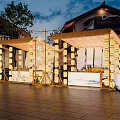 Charming Commercial Outdoor Seating Area With Straw Canopy Lighting And Traditional Buildings