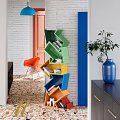 Colorful Geometric Bookshelf With Orange Chair Blue Vase And Plant In Modern Room