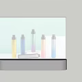 Decorative Ornament Set With Cylindrical Colored Bottles And White Elongated Object On Gray Base
