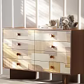 Modern Chest of Drawers Featuring Geometric Patchwork Panels Brass Handles and Decorative Items