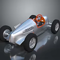 Vintage Silver Race Car With Orange Steering Wheel And Black Tires